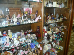 Vintage Dolls Arranged in Glass Case at GiGi's Dolls in Chicago